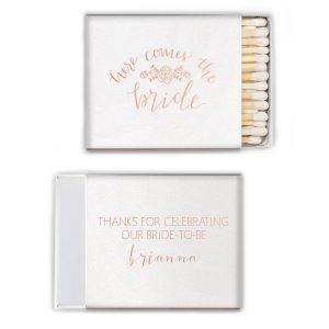 Ignite the bridal shower buzz with the Here Comes The Bride Matchbox, adorned with a floral garland that sings of upcoming vows. Above the bride's sweetly scripted name, a message of gratitude adds warmth to the pre-wedding celebration.