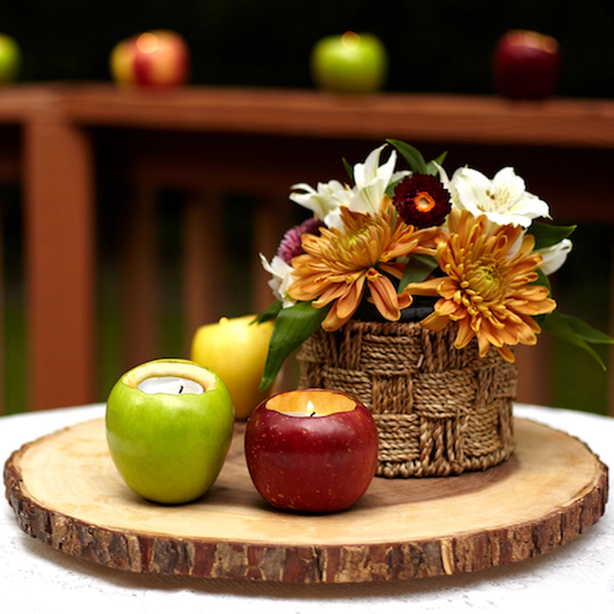 fall centerpiece with apples, flowers and diy votive candle holders