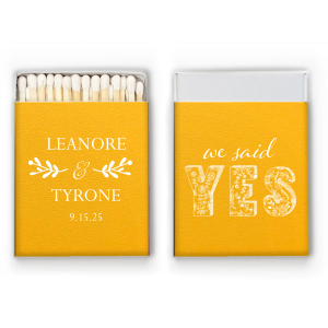 Ignite romance with the We Said Yes Matchbox. This matchbox proudly displays a vibrant "YES" filled with elegant florals, offering a spark of love at every strike. With the couple’s names elegantly displayed, it lights up memories of your special day, one match at a time! 