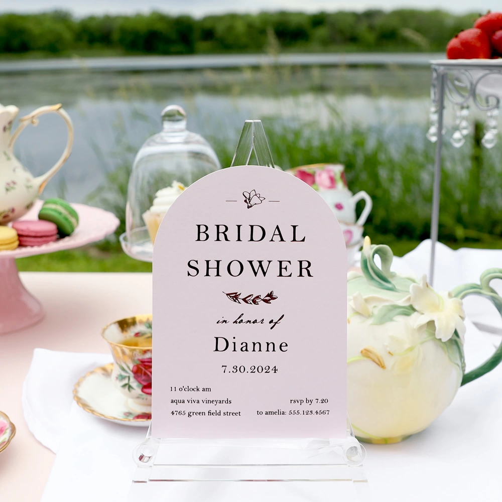 Close up of pink Arch Invite that says Bridal Shower in honor of Dianne