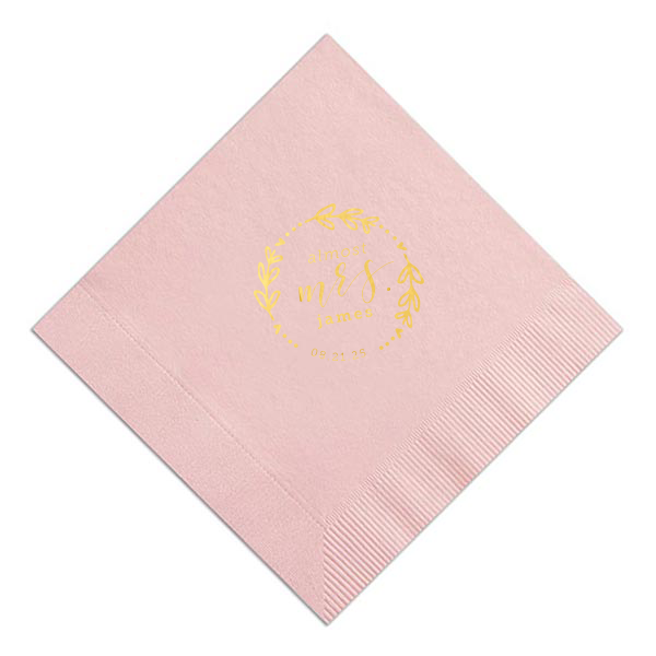 The Almost Mrs Heart Frame Bridal Shower Napkin joyfully heralds the bride-to-be's journey from Miss to Mrs. Encircled by a heart-leaf frame, the flowing, swirling script of "Mrs." takes center stage, accompanied by her soon-to-be last name and the wedding date. A charming, celebratory design!