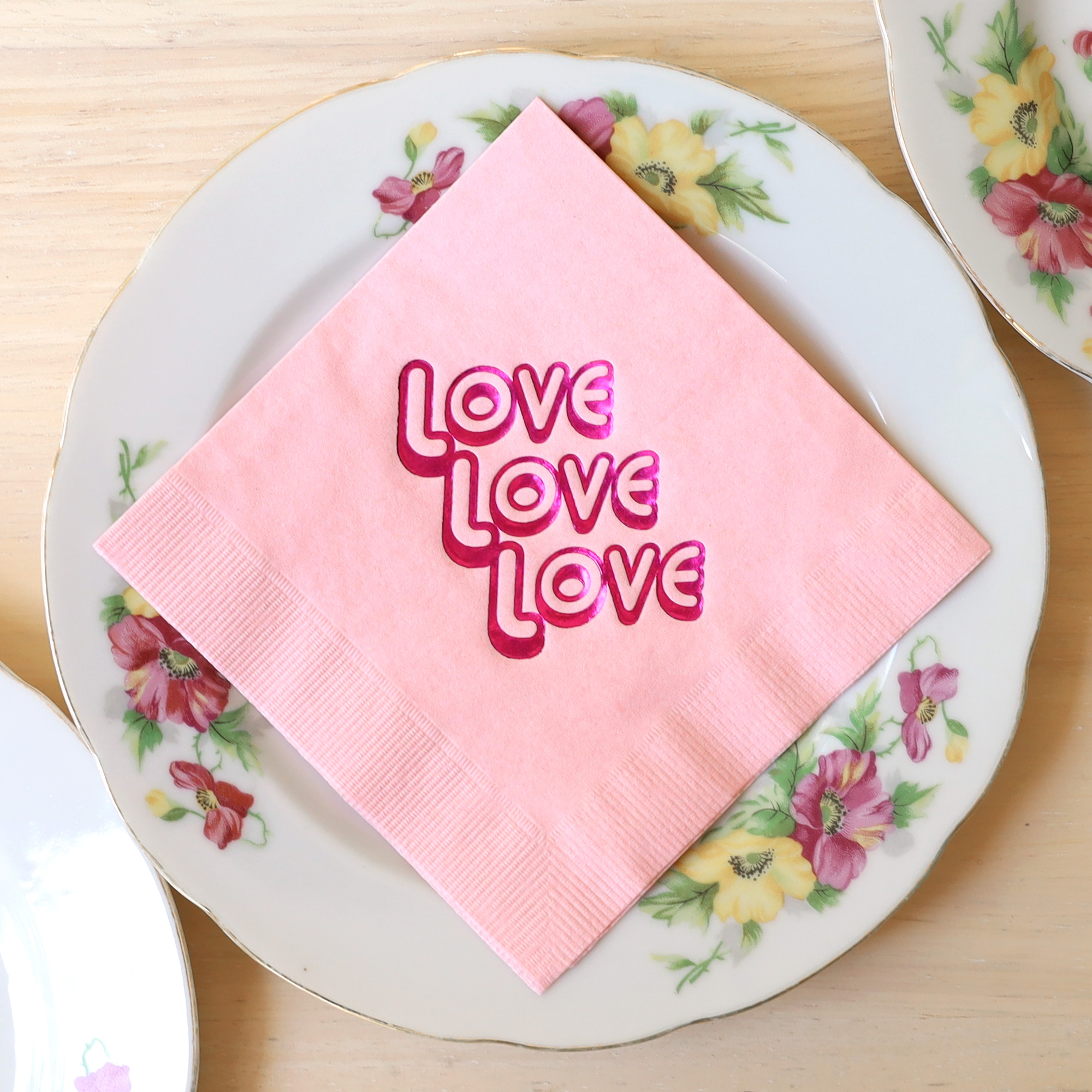 Love Love Love cocktail napkin pack on flower dessert plate