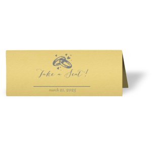 Customize place cards and impress guests with beautiful wedding details. This card leaves space for a name and table number, right under our classic Wedding Rings graphic and catchy calligraphy saying. Choose your theme colors and add your wedding date for a personal touch. 