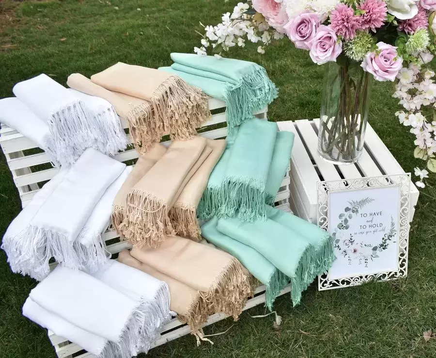 if your guests are a bit chilly during your outdoor reception, provide them with blankets or pashminas in your wedding's colors