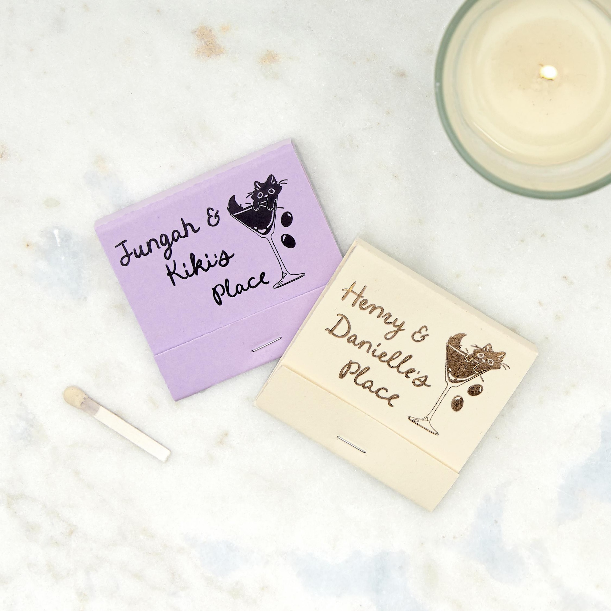 Purple and Ivory matchbooks with a cat in a martini glass