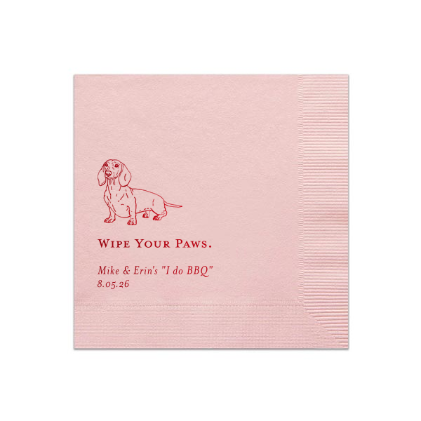 The Dachshund Wipe Your Paws Wedding Napkin delightfully blends humor and pet affection. It showcases a cheerful dachshund illustration above the witty phrase "WIPE YOUR PAWS," playfully connecting napkin utility with the couple's fondness for their dog. Beneath this fun phrase are the couple's names and event date, adding a personalized element.