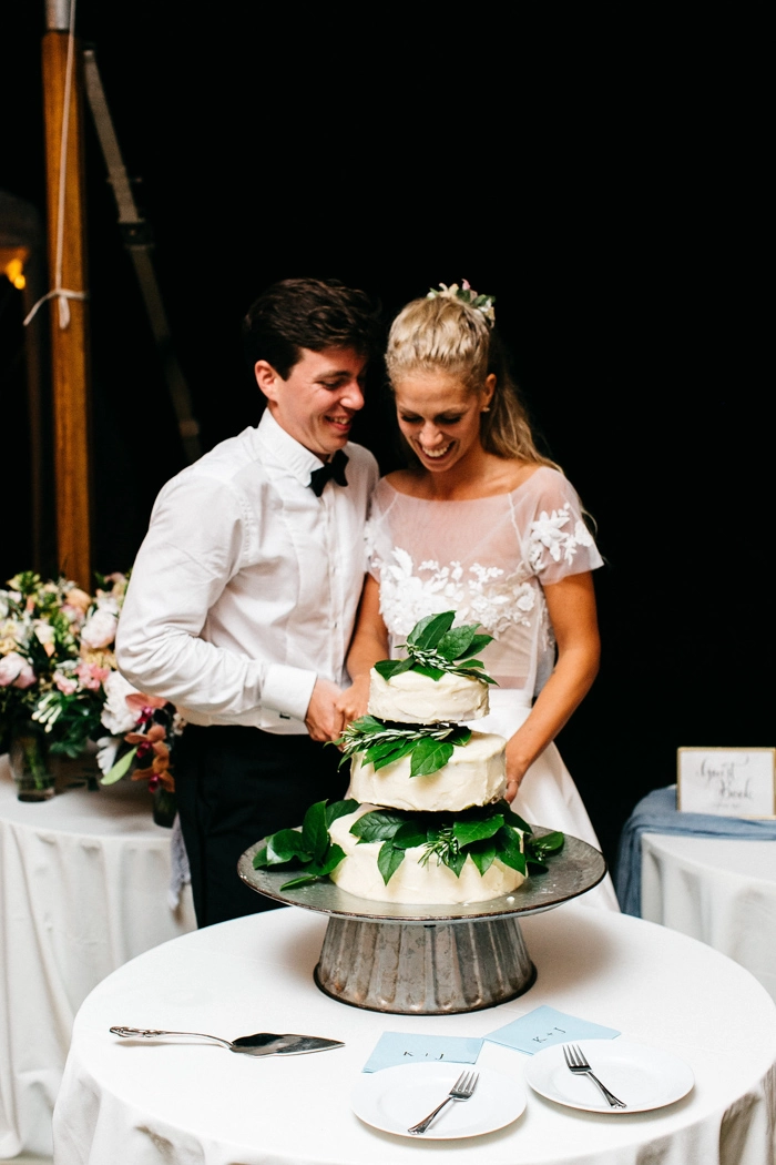 Cutting the wedding cake with FYP napkins near!
