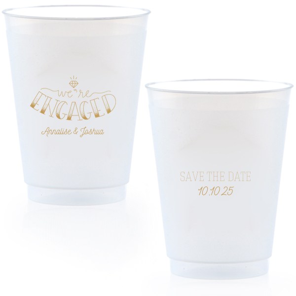 The Diamond Engagement Cup design dazzles with a sparkling diamond graphic and bold "ENGAGED" in 3D artistry. Scripted "we’re" and the couple's names add charm, while the other side cheerfully announces "Save the Date," infusing the cup with celebratory excitement and anticipation.