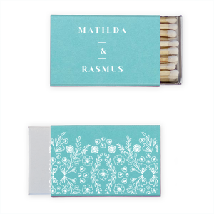 The Cottagecore Floral Matches blend rustic charm with personal sentiment. The couple's first names are showcased, connected by a framed ampersand, symbolizing unity. The reverse side reveals a lush garden motif, rich with flowers, greens, and hidden hearts, evoking a serene, nature-inspired ambiance. 