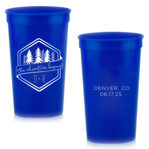 Set off on a new journey with the Adventure Begins Cup, a two-sided celebration of nature and new beginnings. One side, framed by a hexagonal border, showcases ‘the adventure begins’ on a banner, flanked by diverse evergreen trees and the couple’s initials. The other side commemorates the event with the location and date, perfectly encapsulating the spirit of adventure and personal milestones."
