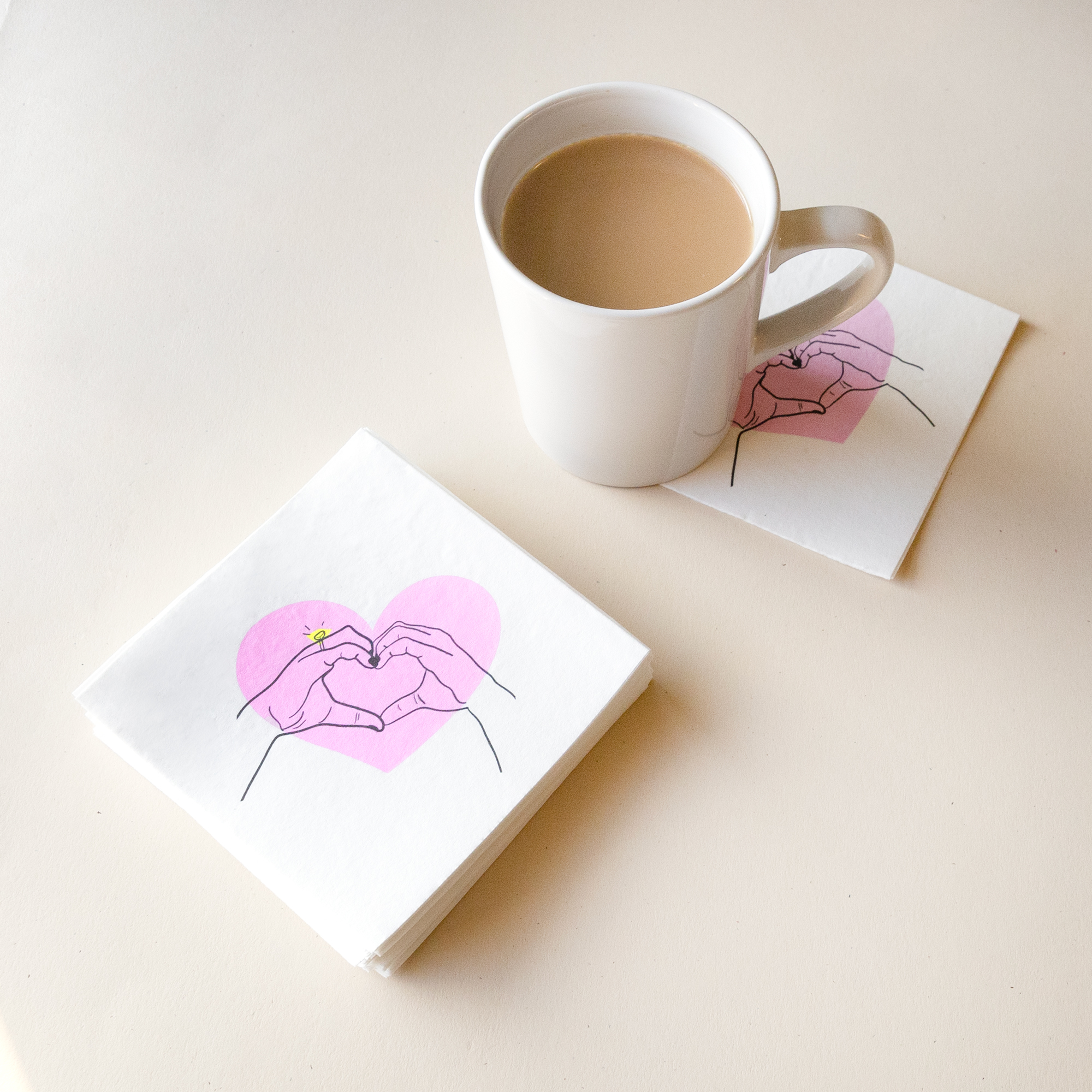 Heart hands napkins styled with a coffee