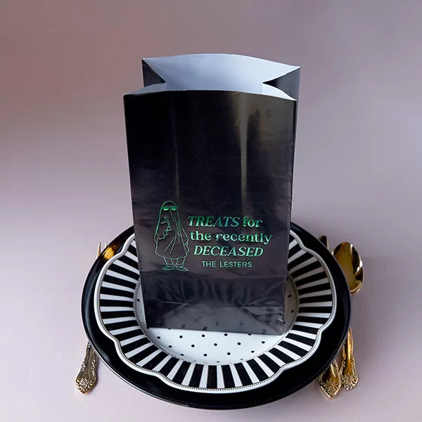 Treats For The Recently Deceased Bag atop a decorative plate