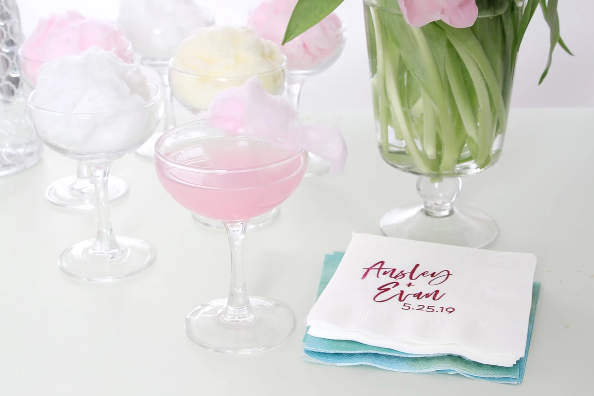 cotton candy cosmopolitan with personalized cocktail napkins