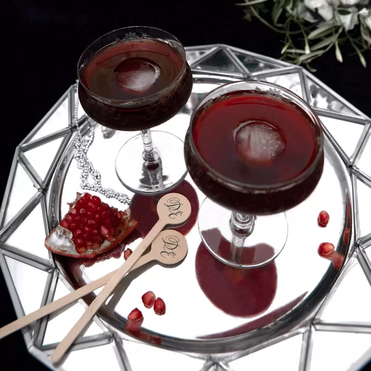 bourbon pomegranate manhattan cocktail recipe with custom drink stirrers