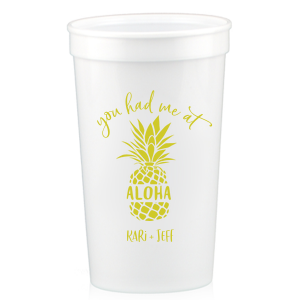 Sip the Tropical Romance. Raise a toast with the You had Me at Aloha Cup. Featuring a charming pineapple graphic with "Aloha" banded across it, this design gives a playful twist to a classic romantic movie line. Perfect for couples who want to add a touch of Hawaiian charm to their special day.

