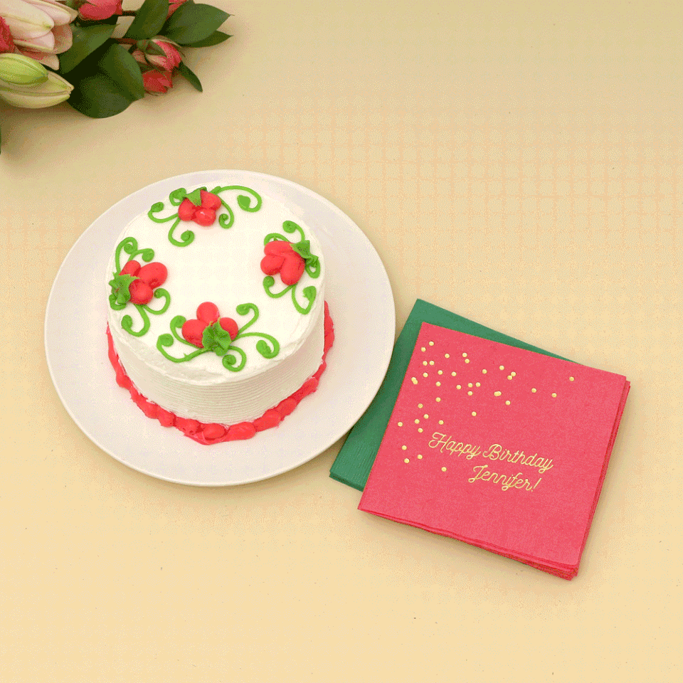 Gif of a cake being cut away with party napkins