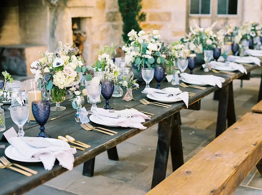 tuscan dinner party with color glasses, peony bouquets and purple napkins