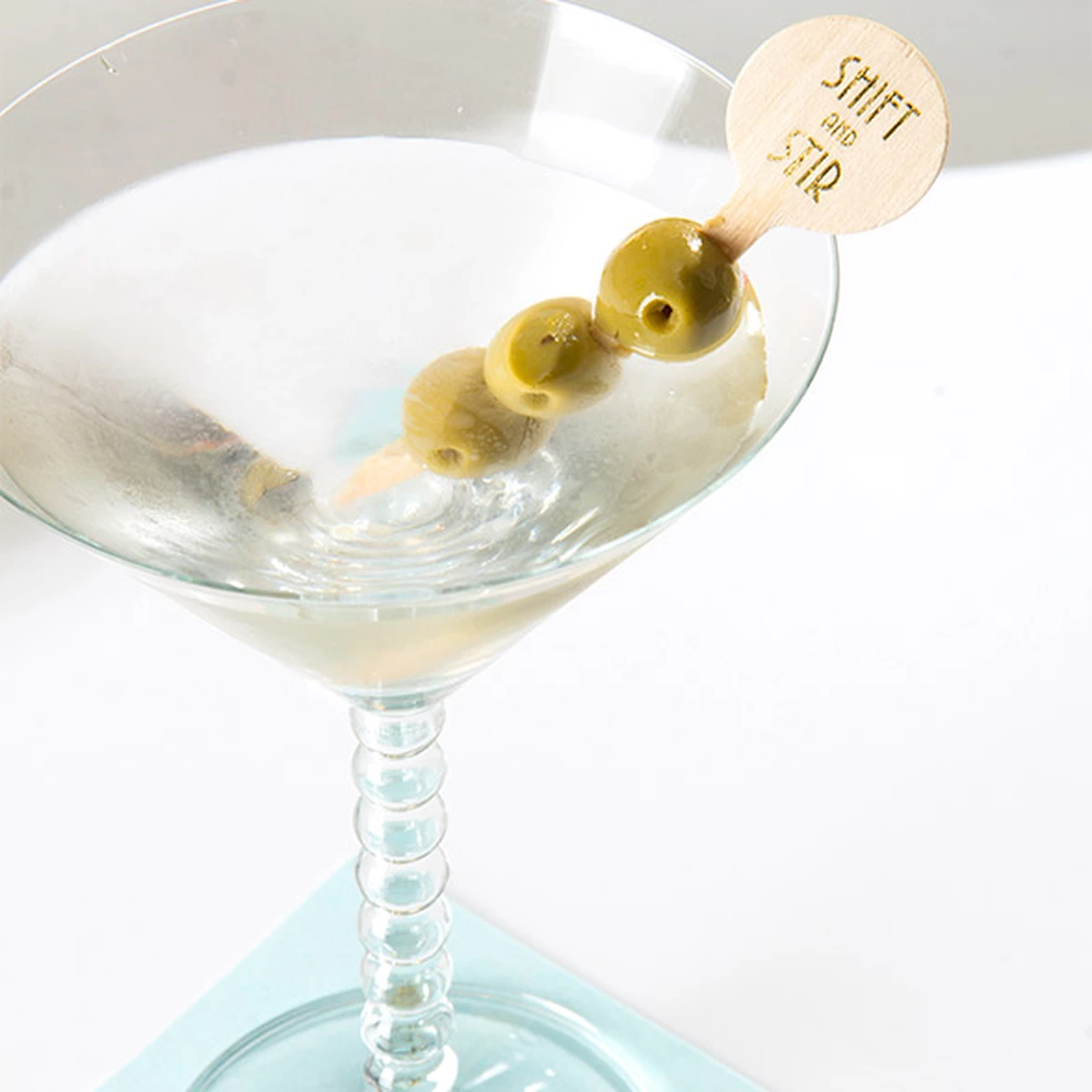 dirty martini with custom cocktail stirrer