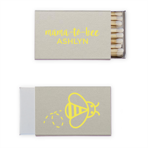 Strike up excitement for the 'Mama to Bee' with these adorable matches, buzzing with anticipation. The Mama to Bee Matchbox design has a sweet bee gracing the back, while the front honors the guest of honor, kindling joy for the baby's impending arrival.