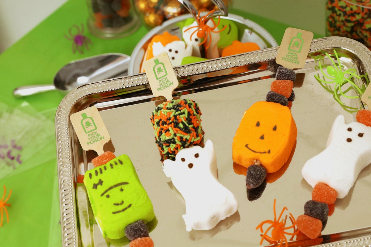 Stir sticks being used as skewers for candy. 