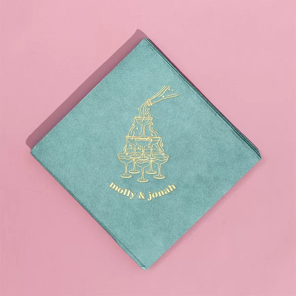 Green and Gold napkin on a pink background
