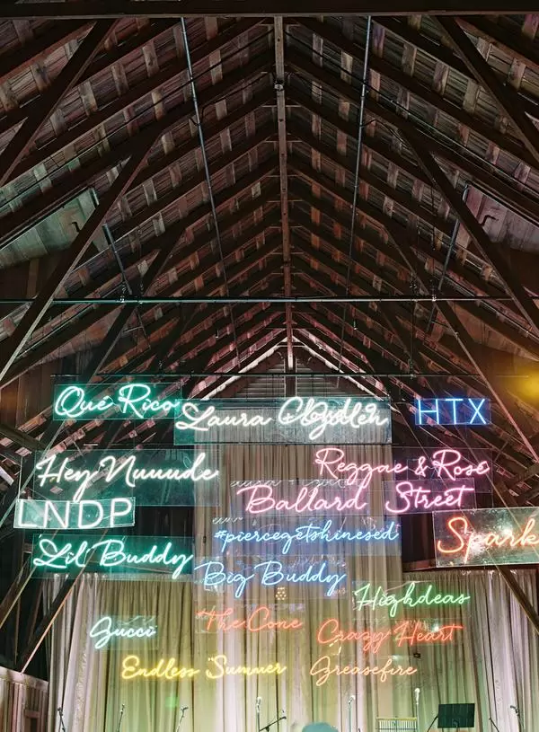 neon wedding signs hanging from the ceiling