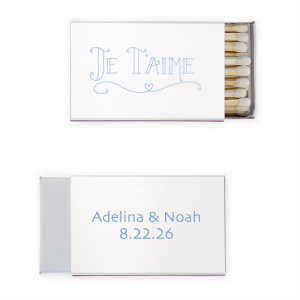 Kindle romance with the Je T'aime Match, whispering 'I love you' in French, adorned with a heartfelt flourish. This matchbox, bearing the couple's names and date, is a tender nod to love with a Parisian touch.