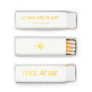 Illuminate your season with the Peace. Joy. Love. Matchbox, casting 'Let your Heart be Light' alongside a radiant star. The family name glows below, sharing a message of hope and inspiration, kindling warmth in every heart it touches.