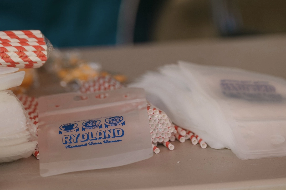 Empty custom drink pouches stacked on a table ready to use at a wedding