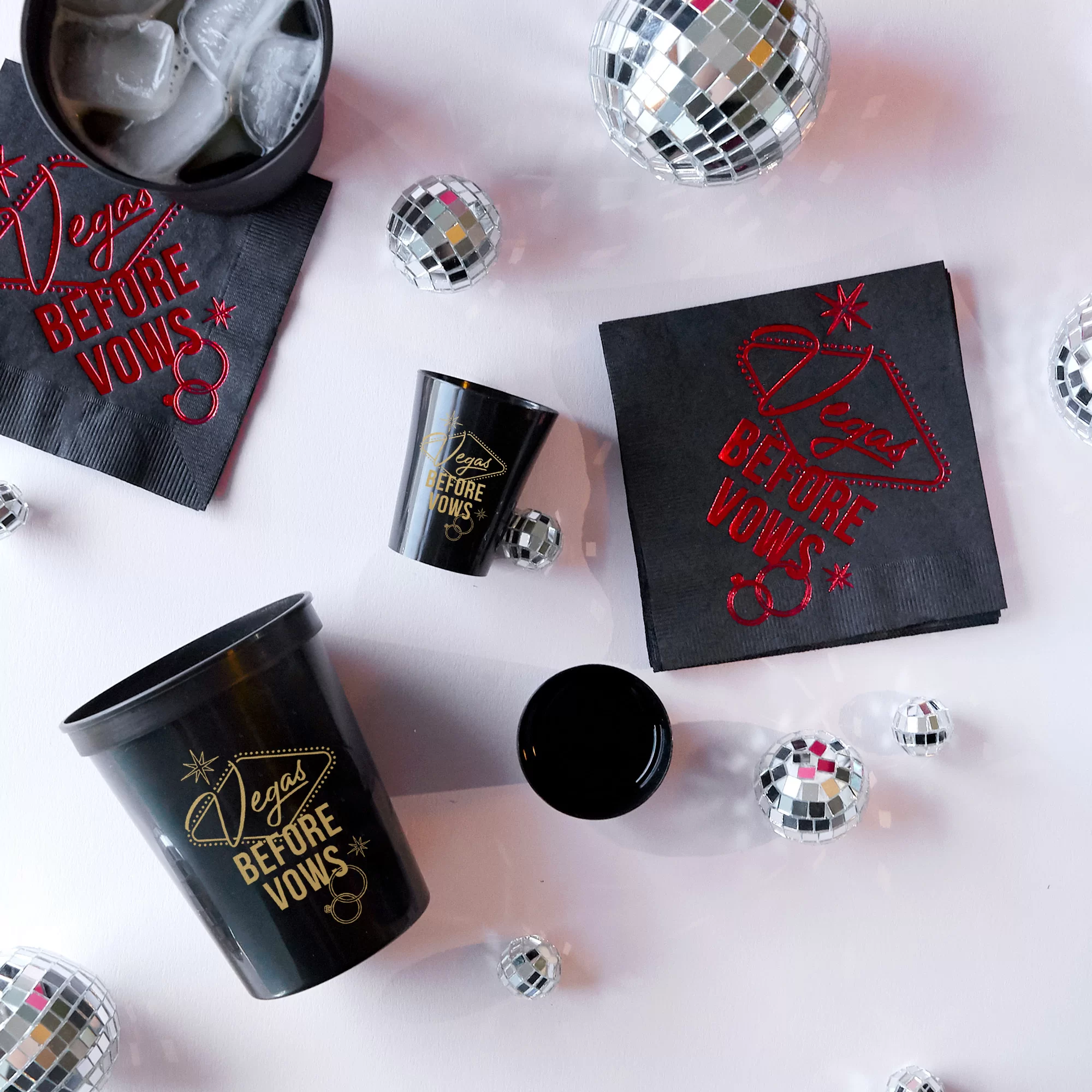Vegas before vows party decor of napkin, cup and shot glass