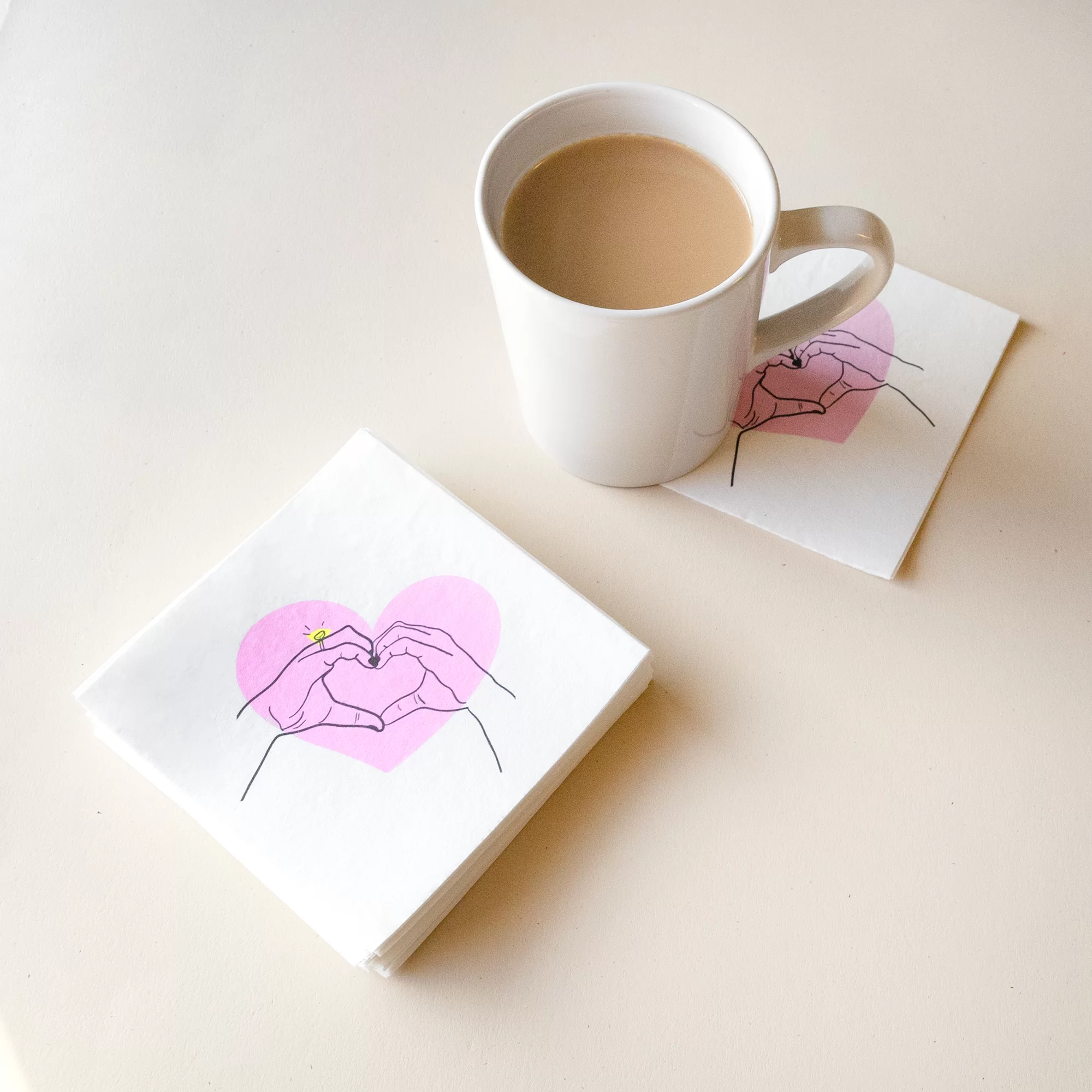 Heart hands napkins styled with a coffee