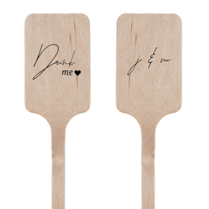 The Drink Me Stir Stick features a charming "Drink Me" message and a sweet heart symbol on one side, and two initials entwined in an elegant, cursive script on the other. This delightful stir stick adds a storybook charm to any beverage, inviting guests to sip and celebrate the magic of the moment. Pairs well with intimate gatherings and romantic wedding receptions.