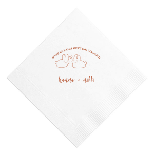 Hop into matrimonial joy with the Some Bunnies Wedding Napkin, complete with an adorable drawing of two bunnies and a heart nestled between them. The playful phrase "Some Bunnies Getting Married" sets a whimsical tone, while the area below awaits the couple's names, scripted with modern elegance. A delightful addition to your wedding tablescapes.