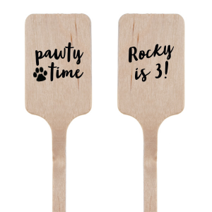 The Pawty Time Stir Stick celebrates milestones with a customized declaration perfect for adding a personal touch to your, your child's, or your pet's special day. The reverse side features an adorable paw print graphic with the playful words "Pawty Time," also in the same relaxed script, setting the tone for a fun-filled event. This charming stirrer is a delightful accessory for birthday parties, pet adoption anniversaries, or any occasion worth throwing a "pawty" for.