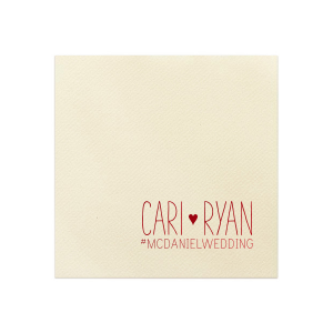 The Heart and Hashtag Napkin design weaves whimsy and modernity, featuring the couple's names in a charming font, unified by a heart. Below, a blank hashtag awaits a personal touch, inviting guests to share memories online—a playful nod to digital age festivities.