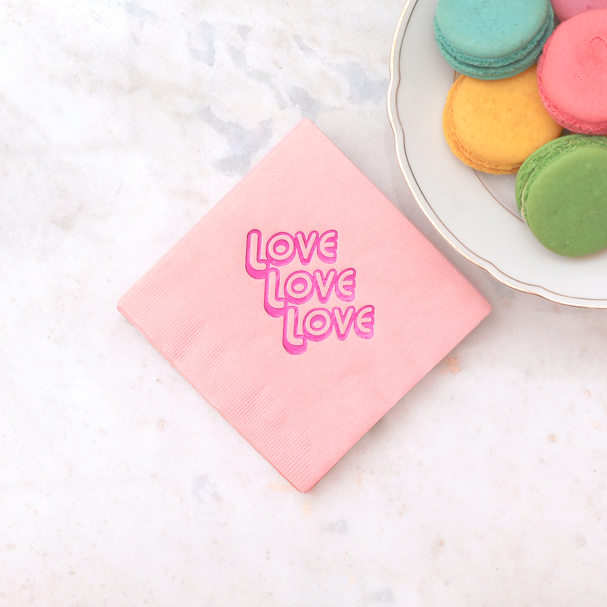 Love Love Love cocktail napkin pack next to macarons
