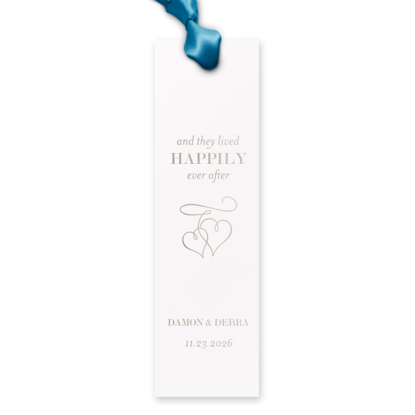 Bookmark the beginning of a lifelong fairy tale with the Happily Ever After Bookmark, adorned with the iconic phrase floating above two interlocked, flourished hearts. Below, the couple's names add a personal touch to this emblem of enduring love