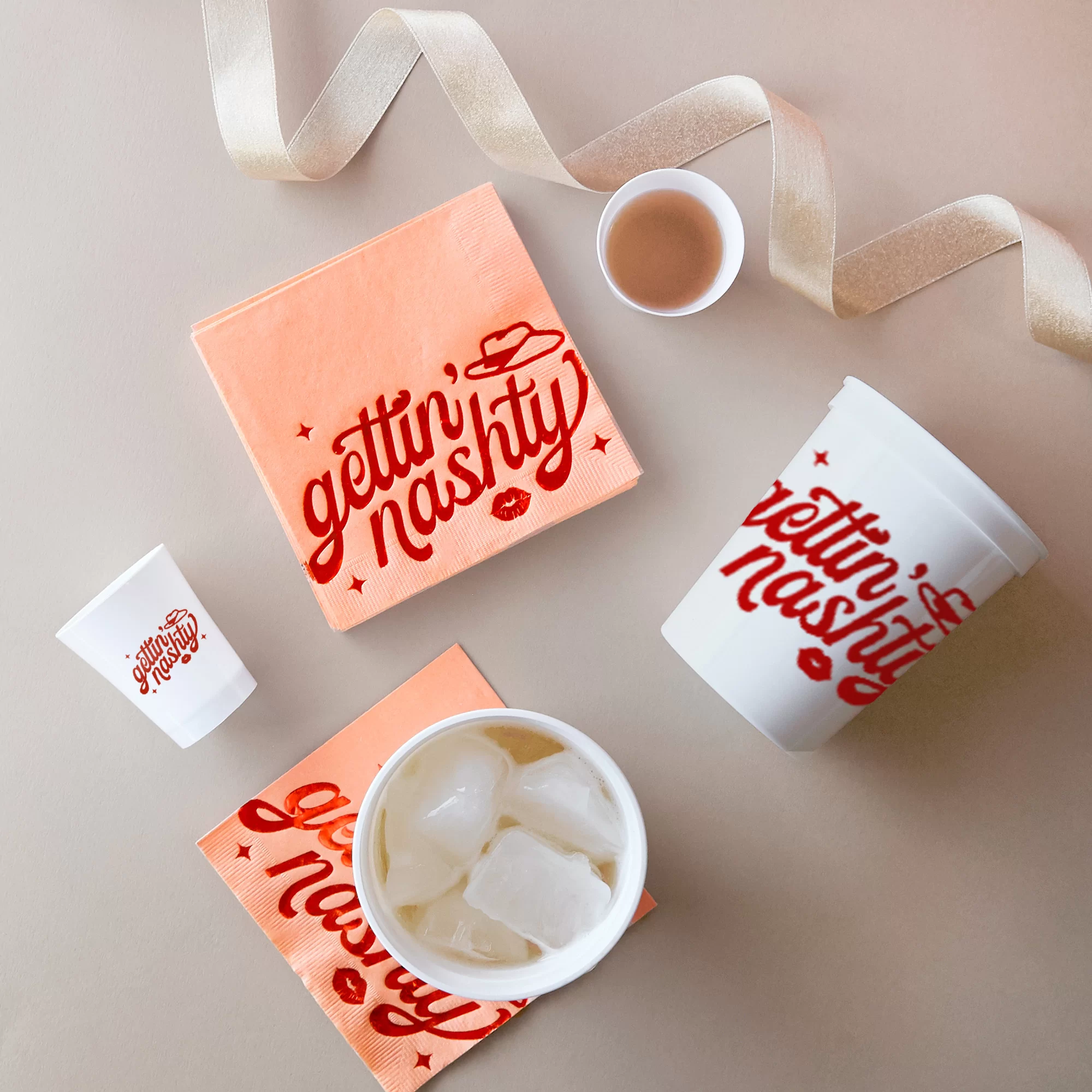 Party scene with white cups and shot glasses