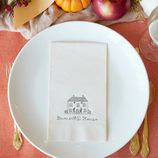 Ivory napkin with house and personalization on a dinner plate