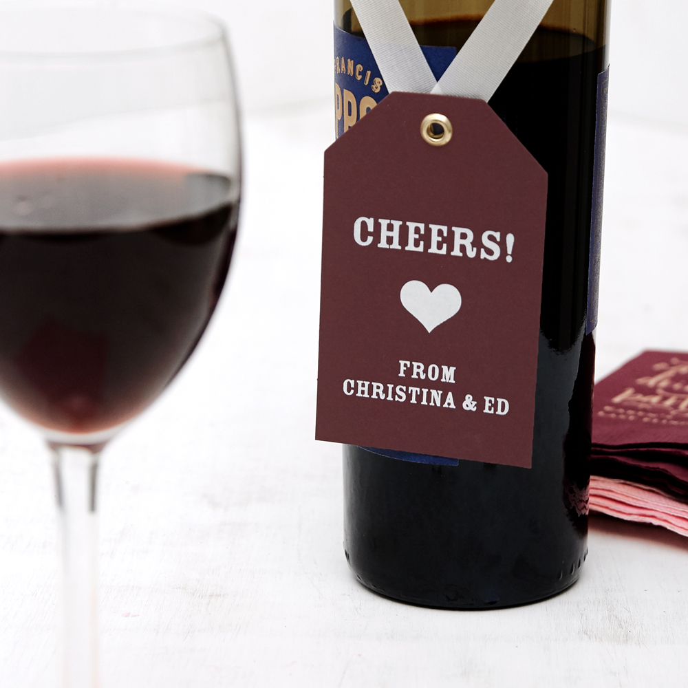 gift tag on a ribbon hanging on a wine bottle