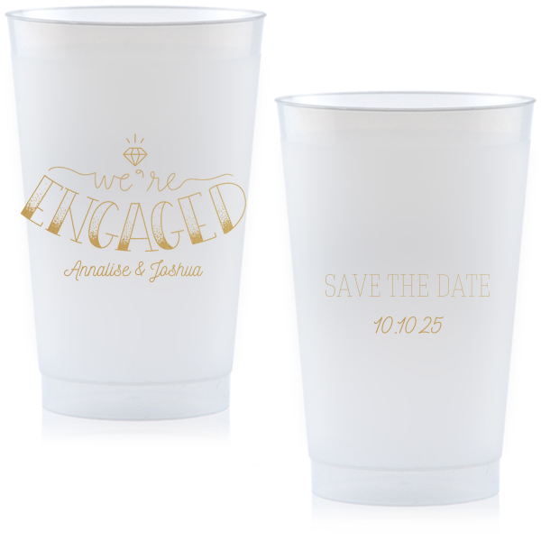The Diamond Engagement Cup design dazzles with a sparkling diamond graphic and bold "ENGAGED" in 3D artistry. Scripted "we’re" and the couple's names add charm, while the other side cheerfully announces "Save the Date," infusing the cup with celebratory excitement and anticipation.