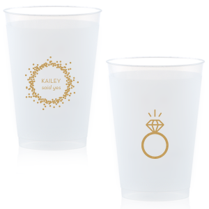 Cheers to the newly betrothed with the Engagement Ring Cup, bursting with celebratory bubbles and a bright 'said yes.' Flip to reveal a sparkling solitaire ring, toasting to the promise of a dazzling future together.