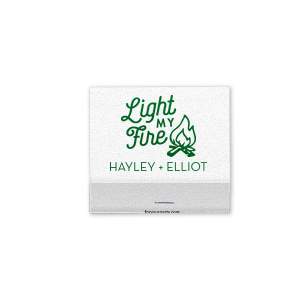 Set the scene with the Light My Fire Matchbook, echoing the classic tune in a design ideal for engagement parties, weddings, or home decor. It displays “Light My Fire” in a playful font, accompanied by a quaint campfire graphic. Below, the couple’s names in bold all-caps add a personal touch, evoking the warmth and romance of a cozy campfire setting."