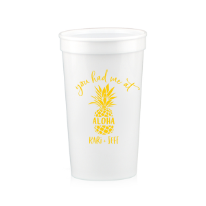 Sip the Tropical Romance. Raise a toast with the You had Me at Aloha Cup. Featuring a charming pineapple graphic with "Aloha" banded across it, this design gives a playful twist to a classic romantic movie line. Perfect for couples who want to add a touch of Hawaiian charm to their special day.

