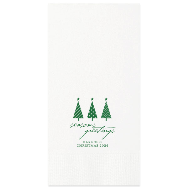 Spruce up your holiday table with the Seasons Greetings Christmas Tree Napkin, where a trio of distinctively decorated trees shines brightly. 'Seasons Greetings' unfurls in joyful script, inviting guests to share in the festive cheer of your celebration.