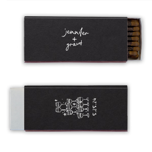  Light up the night with the Kitschy Cocktail Hour Toasting Glasses Matches, a whimsically modern addition to your wedding day. Each matchbox, personalized with the couple's names in a hand-drawn-inspired script, flips to reveal a contemporary line drawing of a wine glass pyramid and the date, perfect for commemorating your toast to forever.