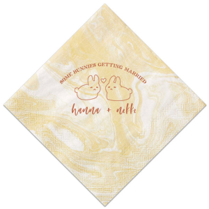 Hop into matrimonial joy with the Some Bunnies Wedding Napkin, complete with an adorable drawing of two bunnies and a heart nestled between them. The playful phrase "Some Bunnies Getting Married" sets a whimsical tone, while the area below awaits the couple's names, scripted with modern elegance. A delightful addition to your wedding tablescapes.