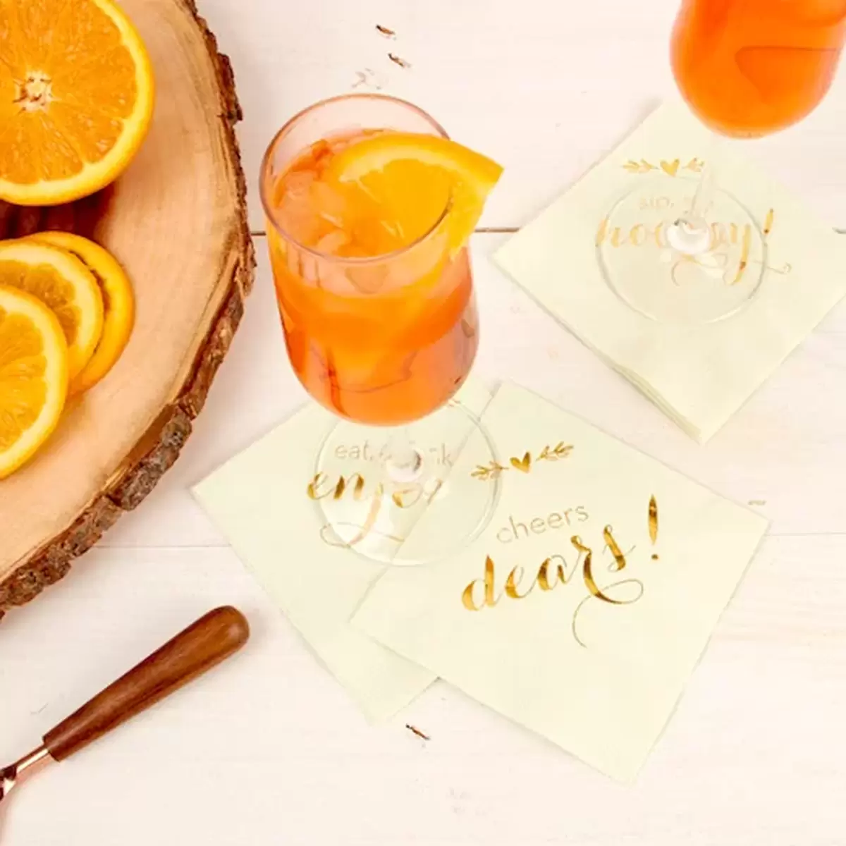 aperol spritz cocktail with oranges and custom printed cocktail napkins in mint with gold foil