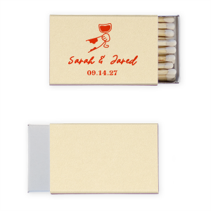Ignite the spark of your wedding day with the Toasting Hands Wedding Matches, featuring an endearing illustration of a cartoon hand with a glass of wine raised in a celebratory toast. Below the image, the couple's names are elegantly written in a charming script, with the event date thoughtfully placed in a classic serif font. These matches are a delightful memento of your union.