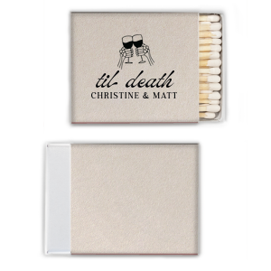 Find the perfect match with the Til Death Toast Match. Heat things up at your event with this striking accessory. Adorned with two skeletal hands clinking wine glasses above personalized text, they are perfect for seasonal weddings or Halloween events.